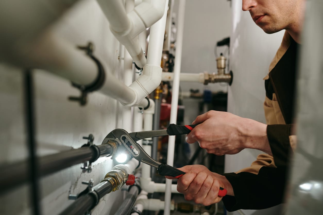 Plumbers maintaining commercial plumbing pipes in Vero Beach