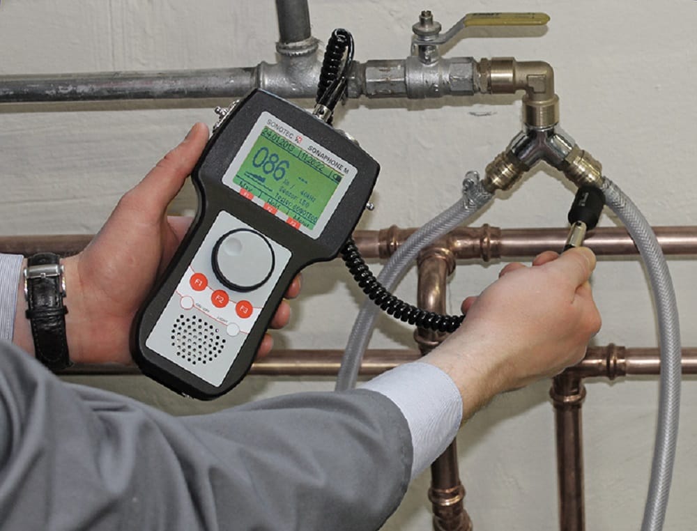 Plumber testing pipes with electronic leak detection equipment in Vero Beach