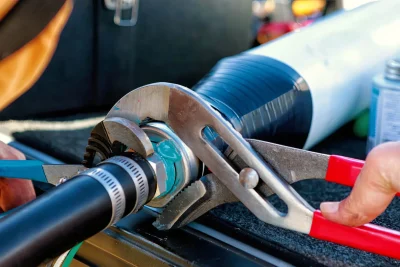 Technician tightening an industrial pipe connection in Vero Beach