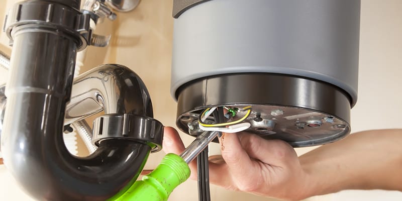 Technician repairing the heating element of a water heater in Vero Beach