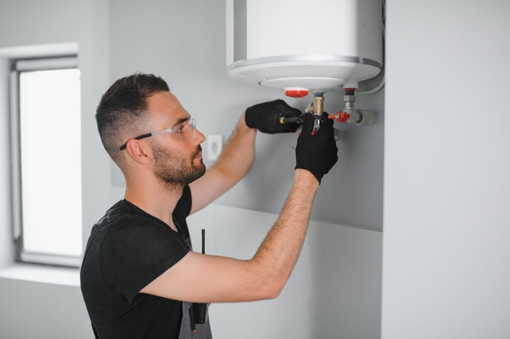 Technician performing water heater maintenance in Vero Beach